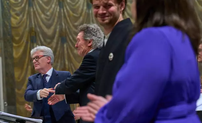 From left, composer James MacMillan, conductor Harry Christopher, tenor Matthew McKinney, and sopranoElizabeth Watts acknowledge the audience's applause at the end of McMillan's oratorio Angels Unawares performed in the Sistine Chapel at the Vatican, Sunday, March 22, 2026. (AP Photo/Domenico Stinellis)