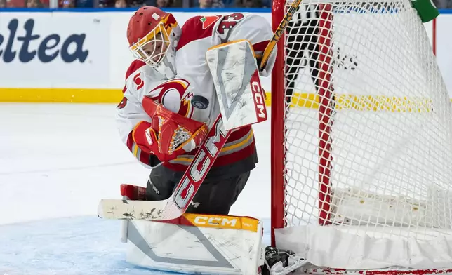 Ottawa Charge goaltender Gwyneth Philips (33) stops the puck against the Vancouver Goldeneyes during the third period of a PWHL hockey game in Vancouver, British Columbia, Saturday, March 14, 2026. (Ethan Cairns/The Canadian Press via AP)