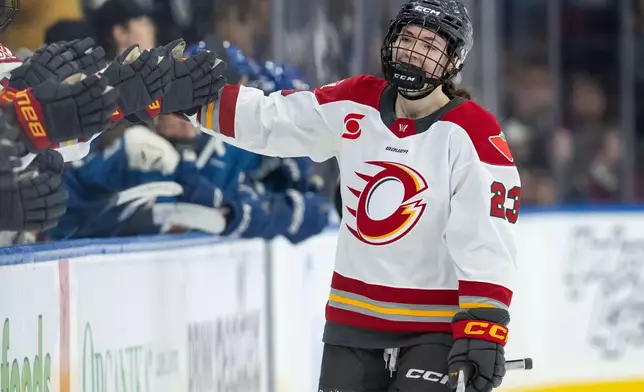 Ottawa Charge's Sarah Wozniewicz (23) celebrates her goal against the Vancouver Goldeneyes with her teammates during the third period of a PWHL hockey game in Vancouver, British Columbia, Saturday, March 14, 2026. (Ethan Cairns/The Canadian Press via AP)