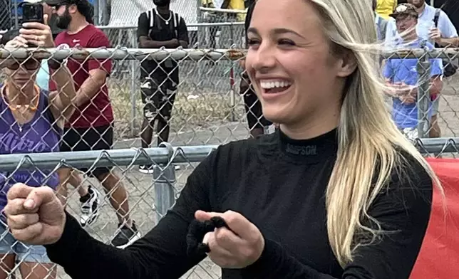 NHRA driver Maddi Gordon jokes with teammates in the staging lanes before an elimination run at the Gatornationals, at Gainesville Raceway in Gainesville, Fla., Sunday, March 8, 2026. (AP Photo/Mark Long)