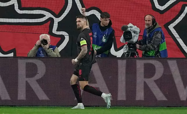 Leverkusen's Robert Andrich celebrates after scoring the opening goal of his team during the Champions League round of 16 first leg soccer match between Bayer Leverkusen and Arsenal FC in Leverkusen, Germany, Wednesday, March 11, 2026. (AP Photo/Martin Meissner)