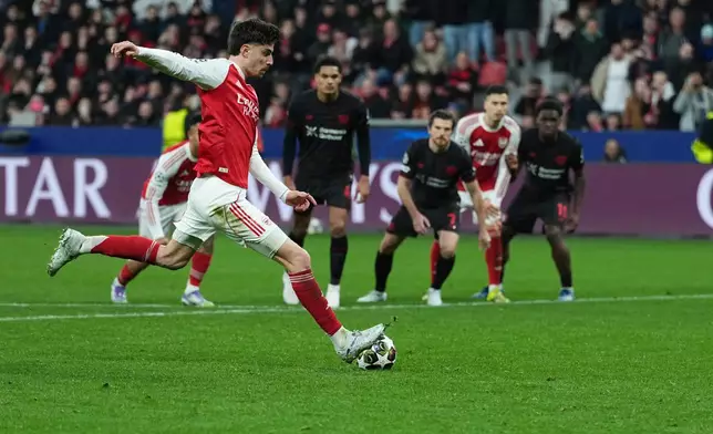 Arsenal's Kai Havertz scores a penalty, his side's first goal, during the Champions League round of 16 first leg soccer match between Bayer Leverkusen and Arsenal FC in Leverkusen, Germany, Wednesday, March 11, 2026. (AP Photo/Martin Meissner)