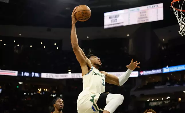Milwaukee Bucks forward Giannis Antetokounmpo (34) dunks against the Atlanta Hawks during the first half of an NBA basketball game Wednesday, March 4, 2026, in Milwaukee. (AP Photo/Jeffrey Phelps)