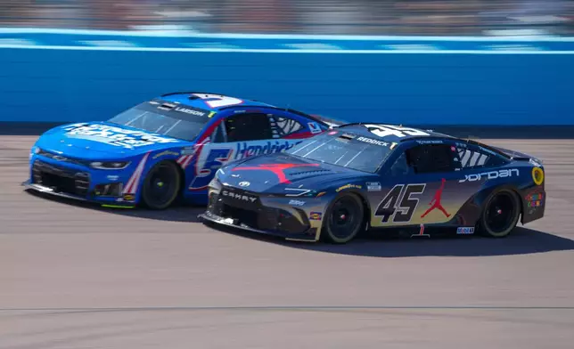 Kyle Larson (5) and Tyler Reddick (45) are side by side during a NASCAR Cup Series auto race at Phoenix Raceway, Sunday, March 8, 2026, in Avondale, Ariz. (AP Photo/Darryl Webb)