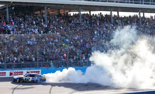 Ryan Blaney (12) does a burnout after winning a NASCAR Cup Series auto race at Phoenix Raceway, Sunday, March 8, 2026, in Avondale, Ariz. (AP Photo/Darryl Webb)