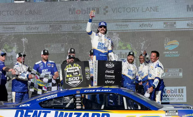 Ryan Blaney celebrates in Victory Lane after winning a NASCAR Cup Series auto race at Phoenix Raceway, Sunday, March 8, 2026, in Avondale, Ariz. (AP Photo/Darryl Webb)
