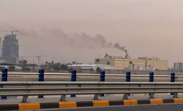 Smoke rises from the U.S. embassy building in Baghdad, Iraq, Saturday, March 14, 2026. (AP Photo/Ali Jabar)