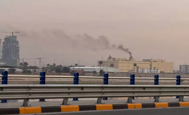 Smoke rises from the U.S. embassy building in Baghdad, Iraq, Saturday, March 14, 2026. (AP Photo/Ali Jabar)