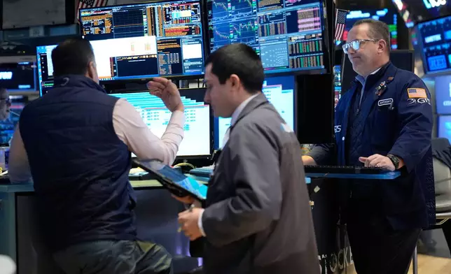 Traders work on the floor at the New York Stock Exchange in New York, Thursday, March 19, 2026. (AP Photo/Seth Wenig)