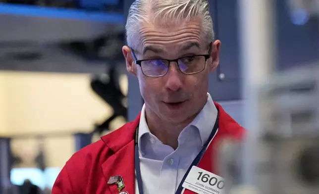 John Gorman works on the floor at the New York Stock Exchange in New York, Thursday, March 19, 2026. (AP Photo/Seth Wenig)