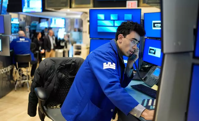 Alexander Weitzman works on the floor at the New York Stock Exchange in New York, Wednesday, March 25, 2026. (AP Photo/Seth Wenig)