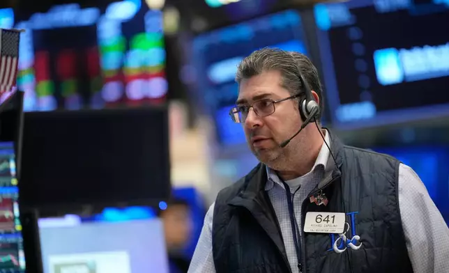 Michael Capolino works on the floor at the New York Stock Exchange in New York, Thursday, March 19, 2026. (AP Photo/Seth Wenig)