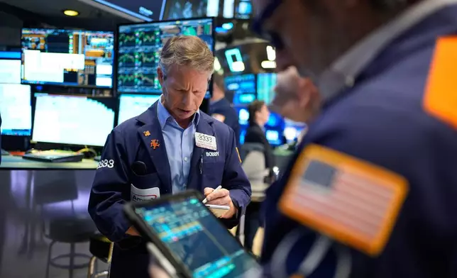 Bobby Charmak works on the floor at the New York Stock Exchange in New York, Wednesday, March 25, 2026. (AP Photo/Seth Wenig)