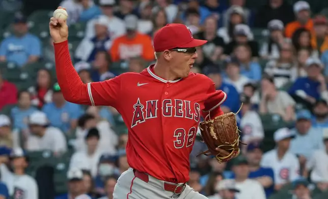 Los Angeles Angels pitcher Ryan Johnson (32) pitches against the Chicago Cubs during the first inning in a baseball game, Monday, March 30, 2026, in Chicago. (AP Photo/David Banks)