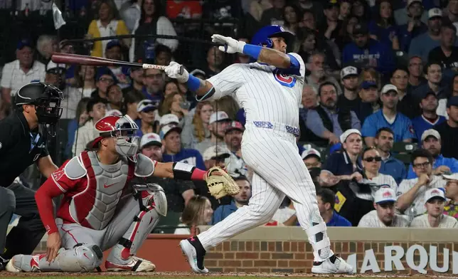 Chicago Cubs' Moisés Ballesteros hits a two-run single against the Los Angeles Angels during the third inning in a baseball game Monday, March 30, 2026, in Chicago. (AP Photo/David Banks)