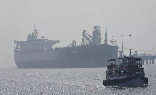 Liberia-flagged tanker Shenlong Suezmax, carrying crude oil from Saudi Arabia, that arrived clearing the Strait of Hormuz, is seen at the Mumbai Port in Mumbai, India, Thursday, March 12, 2026. (AP Photo/Rafiq Maqbool)