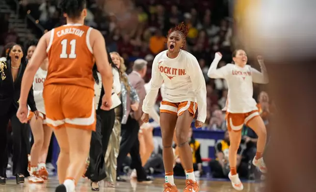 Texas celebrates after scoring during the first half of an NCAA college basketball game against South Carolina in the final of the Southeastern Conference tournament, Sunday, March 8, 2026, in Greenville, S.C. (AP Photo/Chris Carlson)
