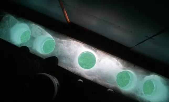 Holes for ice fishing are made on the frozen Lake Simcoe in the Innisfil area north of Toronto, Wednesday, Jan. 7, 2026. (AP Photo/Kamran Jebreili)