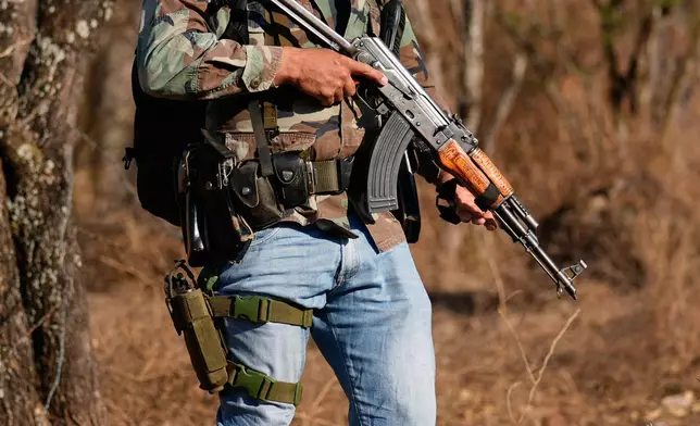 A member of a local self-defense group formed by residents in response to cartel violence stands guard in Guajes de Ayala, Mexico, Tuesday, March 10, 2026. (AP Photo/Marco Ugarte)