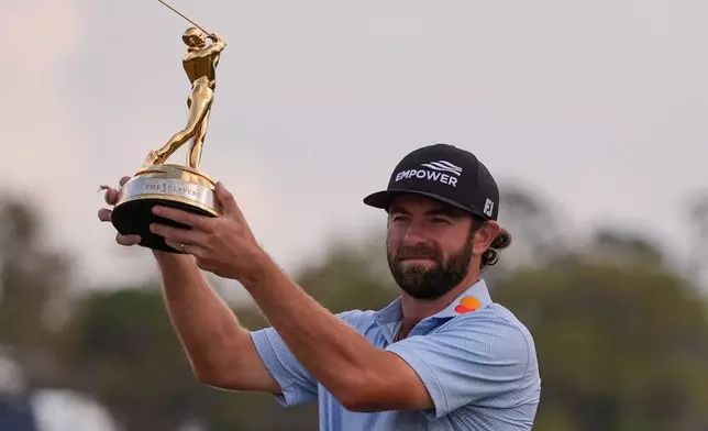 Cameron Young holds the The Players Championship Trophy after the final round of The Players Championship golf tournament, Sunday, March 15, 2026, in Ponte Vedra Beach, Fla. (AP Photo/Gerald Herbert)