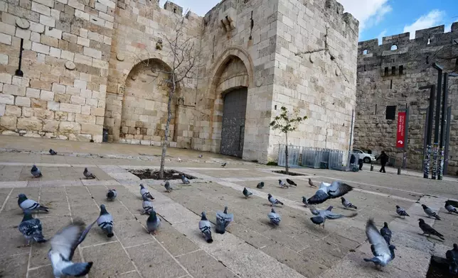 A locked Jaffa Gate in Jerusalem's Old City stands closed to visitors amid the war with Iran, Friday, March 27, 2026. (AP Photo/Mahmoud Illean)