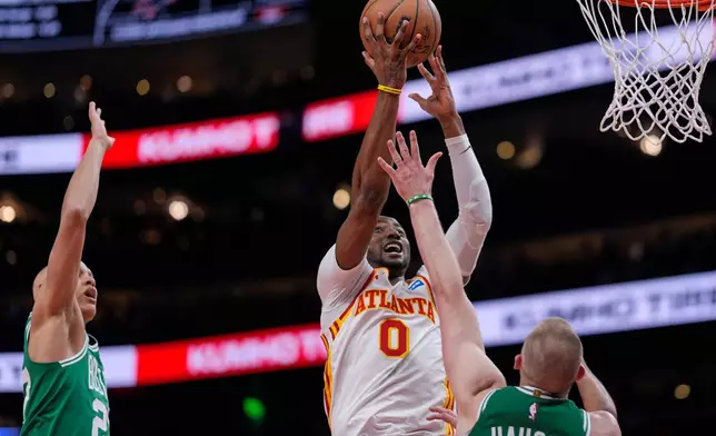 Atlanta Hawks forward Jonathan Kuminga (0) shoots against Boston Celtics forward Sam Hauser (30) in the first half of an NBA basketball game, Monday, March 30, 2026, in Atlanta. (AP Photo/Mike Stewart)