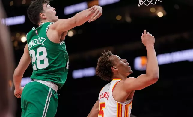 Atlanta Hawks guard Dyson Daniels (5) shoots against Boston Celtics guard Hugo Gonzalez (28) in the first half of an NBA basketball game, Monday, March 30, 2026, in Atlanta. (AP Photo/Mike Stewart)