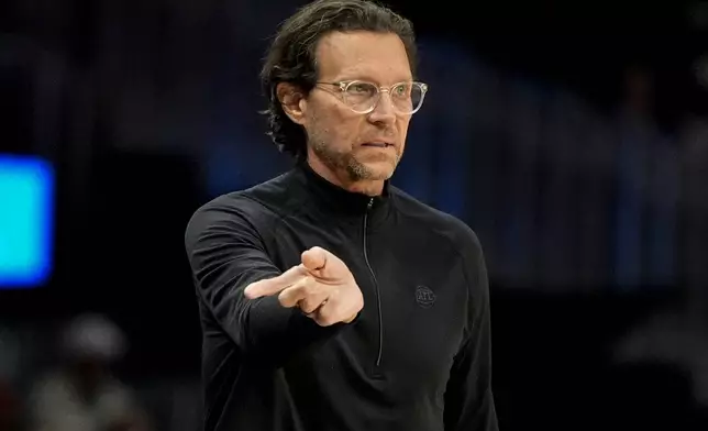 Atlanta Hawks head coach Quin Snyder speaks in the first half of an NBA basketball game against the Boston Celtics, Monday, March 30, 2026, in Atlanta. (AP Photo/Mike Stewart)