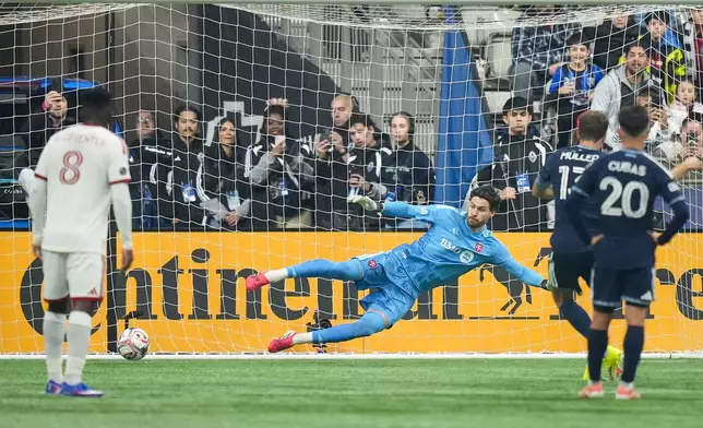Toronto FC goalkeeper Luka Gavran allows a goal to Vancouver Whitecaps' Thomas Muller, back right, on a penalty kick during the first half of an MLS soccer match, in Vancouver, on Saturday, Feb. 28, 2026. (Darryl Dyck/The Canadian Press via AP)