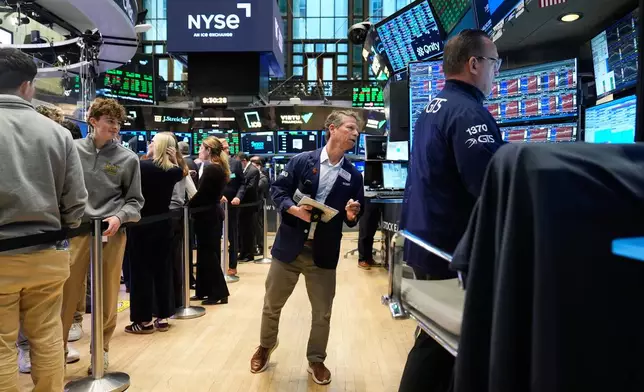 Bobby Charmak works on the floor at the New York Stock Exchange in New York, Monday, March 30, 2026. (AP Photo/Seth Wenig)