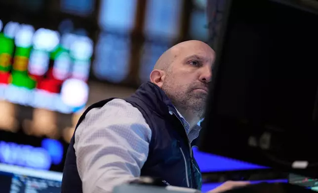 James Denaro works on the floor at the New York Stock Exchange in New York, Monday, March 30, 2026. (AP Photo/Seth Wenig)
