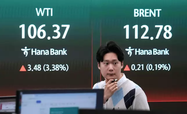 A currency trader reacts near a screen showing international oil prices at the foreign exchange dealing room of the Hana Bank headquarters in Seoul, South Korea, Tuesday, March 31, 2026. (AP Photo/Ahn Young-joon)