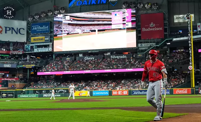 Los Angeles Angels designated hitter Mike Trout reacts after striking out as the ABS replay shows on the screen during the first inning of a baseball game against the Houston Astros in Houston, Sunday, March 29, 2026. (AP Photo/Ashley Landis)