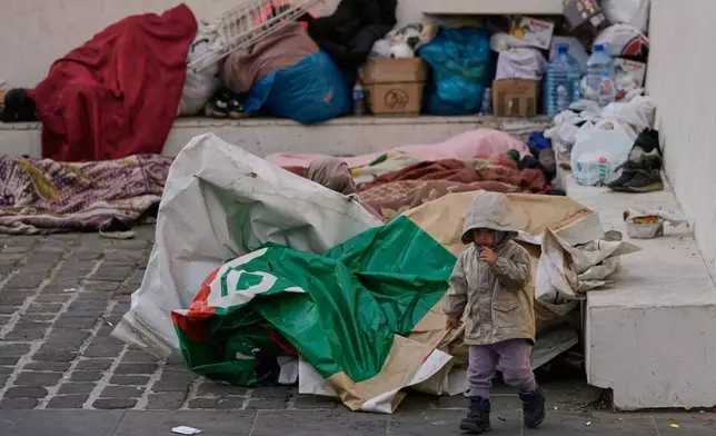 Displaced people fleeing Israeli airstrikes in Dahiyeh, Beirut's southern suburbs, sleep at Martyrs' Square in downtown Beirut, Lebanon, Saturday, March 7, 2026. (AP Photo/Bilal Hussein)
