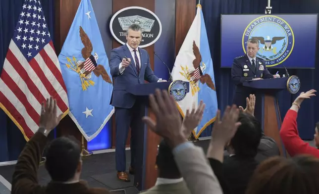 Defense Secretary Pete Hegseth and Chairman of the Joint Chiefs of Staff Gen. Dan Caine take questions during a press briefing at the Pentagon, Monday, March 2, 2026, in Washington. (AP Photo/Mark Schiefelbein)