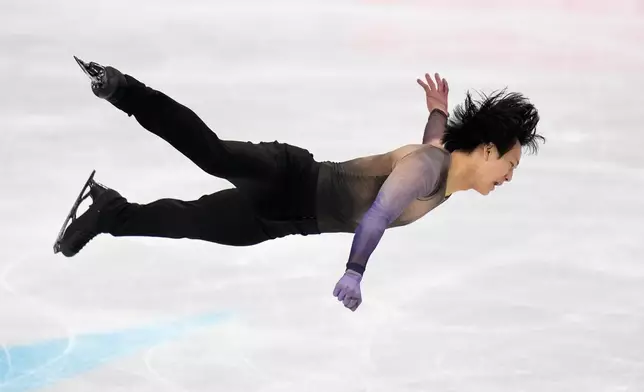 Adam Siao Him Fa from France competes during the men's short program at the Figure Skating World Championships in Prague, Czech Republic, Thursday, March 26, 2026. (AP Photo/Petr David Josek)