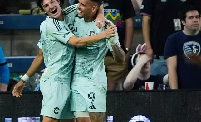Colorado Rapids midfielder Paxten Aaronson, left, celebrates with forward Rafael Navarro (9) after Navarro scored a goal during the second half of an MLS soccer match against Sporting Kansas City, Saturday, March 21, 2026, in Kansas City, Kan. (AP Photo/Charlie Riedel)