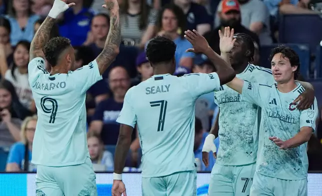 Colorado Rapids midfielder Paxten Aaronson, right, celebrates with teammates after scoring a goal during the first half of an MLS soccer match against Sporting Kansas City, Saturday, March 21, 2026, in Kansas City, Kan. (AP Photo/Charlie Riedel)