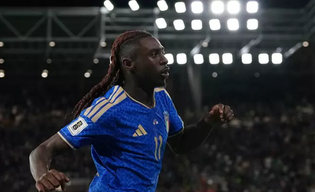 Italy's Moise Kean celebrates scoring his side's second goal during the World Cup qualifying play-off soccer match between Italy and Northern Ireland, in Bergamo, Italy, Thursday, March 26, 2026. (AP Photo/Antonio Calanni)