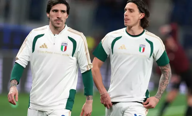 Italy's Sandro Tonali, left, and Italy's Riccardo Calafiori warm up prior to the World Cup qualifying play-off soccer match between Italy and Northern Ireland, in Bergamo, Italy, Thursday, March 26, 2026. (AP Photo/Antonio Calanni)