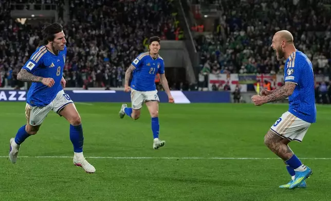Teammates run towards Italy's Sandro Tonali, left, who scored his side's first goal during the World Cup qualifying play-off soccer match between Italy and Northern Ireland, in Bergamo, Italy, Thursday, March 26, 2026. (AP Photo/Antonio Calanni)