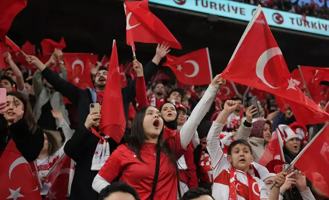 Turkish supporters cheer at the stand prior the 2026 World Cup playoff semifinal soccer match between Turkey and Romania, in Istanbul, Turkey, Thursday, March 26, 2026. (AP Photo)