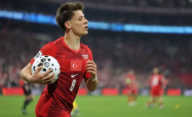 Turkey's Arda Guler grabs the ball during the 2026 World Cup playoff semifinal soccer match between Turkey and Romania, in Istanbul, Turkey, Thursday, March 26, 2026. (AP Photo)