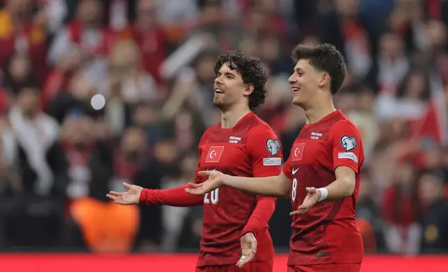 Turkey's Ferdi Kadioglu, left, and Arda Guler celebrate at the end of the 2026 World Cup playoff semifinal soccer match between Turkey and Romania, in Istanbul, Turkey, Thursday, March 26, 2026. (AP Photo)