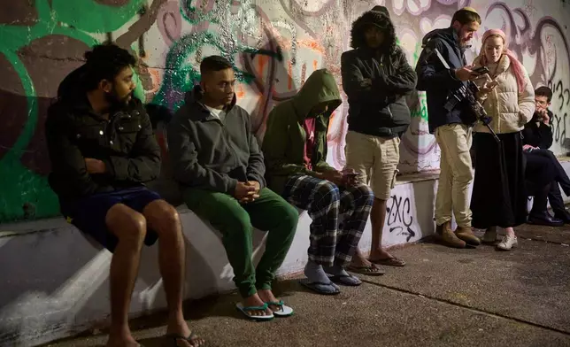 People take shelter in an Underground tunnel as air raid sirens signal a warning of incoming Iranian missiles in Jerusalem, Thursday, March 19, 2026. (AP Photo/Ohad Zwigenberg)
