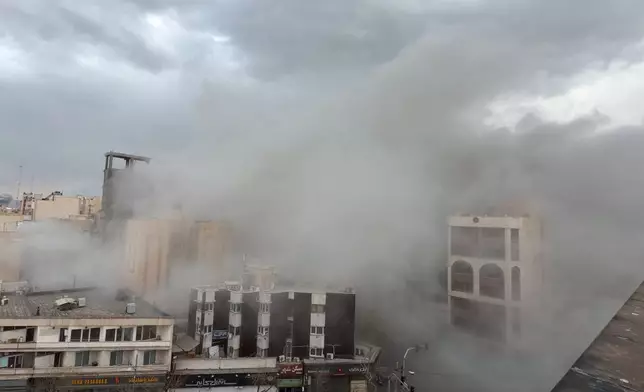 Smoke engulfs a street after a strike in Tehran, Iran, Monday, March 2, 2026. (AP Photo/Mohsen Ganji)