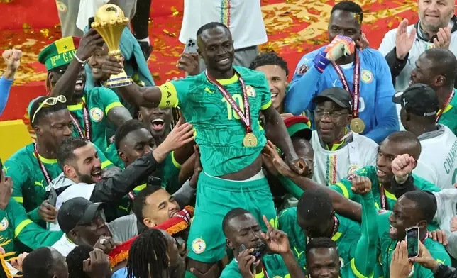FILE - Senegal's Sadio Mane holds the trophy aloft as he celebrates with teammates after winning the Africa Cup of Nations final soccer match between Senegal and Morocco in Rabat, Morocco, Sunday, Jan. 18, 2026. (AP Photo/Youssef Loulidi, File)