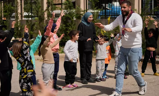 Displaced children who fled Israeli strikes from south Lebanon, take part in activities at a school turned shelter, in the southern port city of Sidon, Lebanon, Wednesday, March 18, 2026. (AP Photo/Mohammed Zaatari)