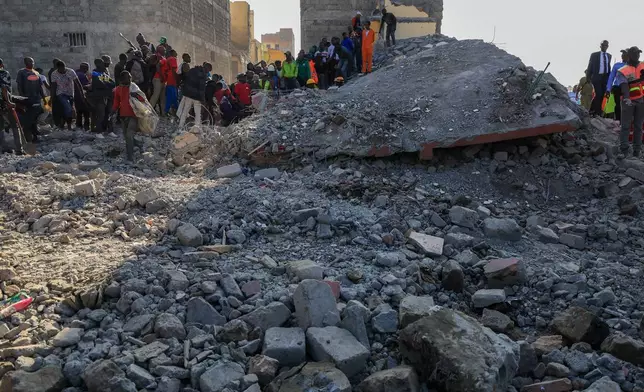 Rescuers search for victims and survivors of a building collapse in Kenya's capital Nairobi Monday, March 16, 2026. (AP Photo/Andrew Kasuku)