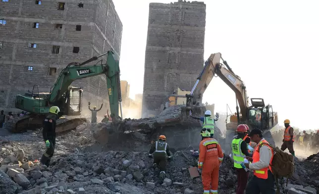 Rescuers search for victims and survivors of a building collapse in Kenya's capital Nairobi, Monday, March 16, 2026. (AP Photo/Andrew Kasuku)